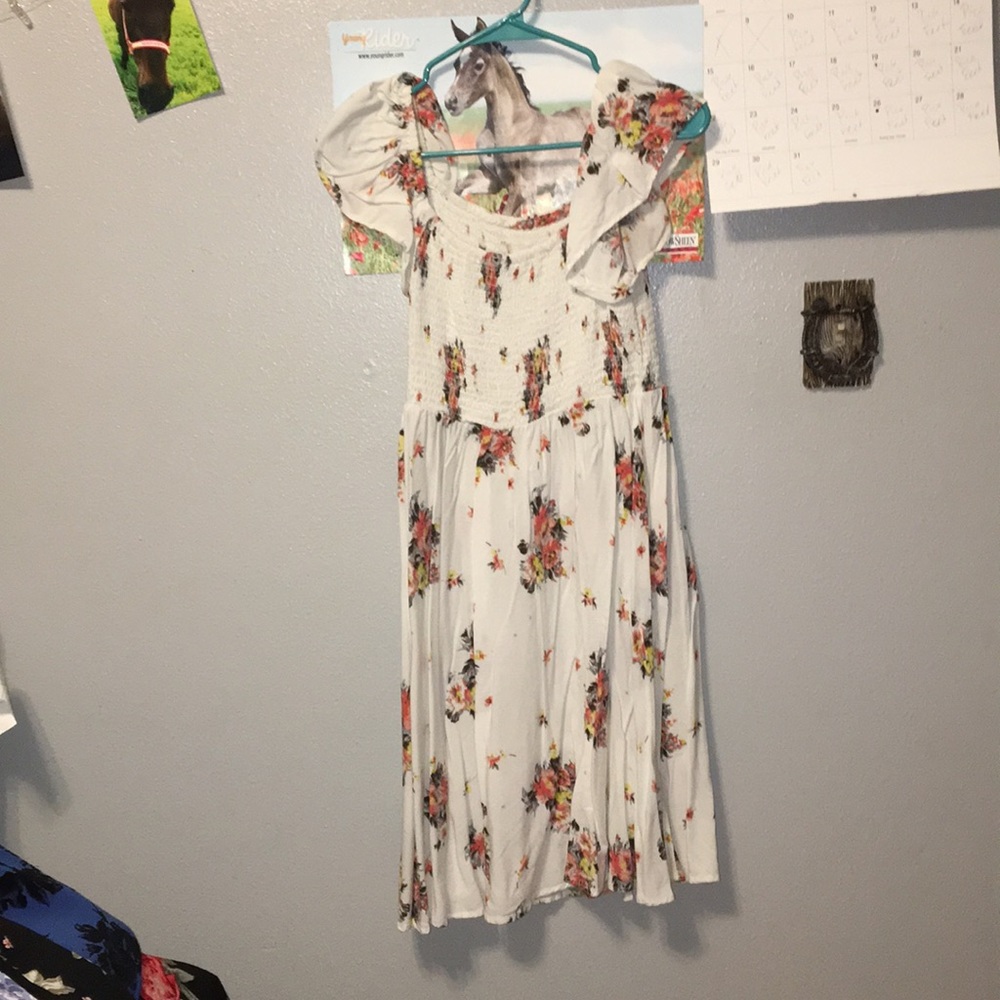White, off shoulder dress.